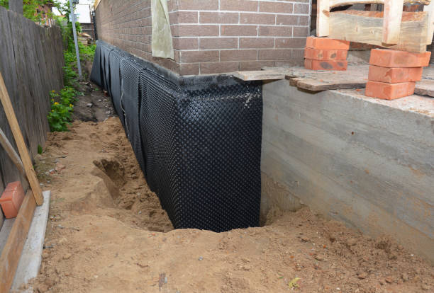 Happy homeowners after waterproofing job in Garrett